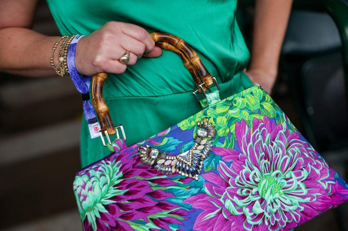 Kelly Flanagan brought a bright blue and purple purse to match her outfit during Kentucky Derby 151 at Churchill Downs May 3, 2025.&nbsp;&nbsp;
