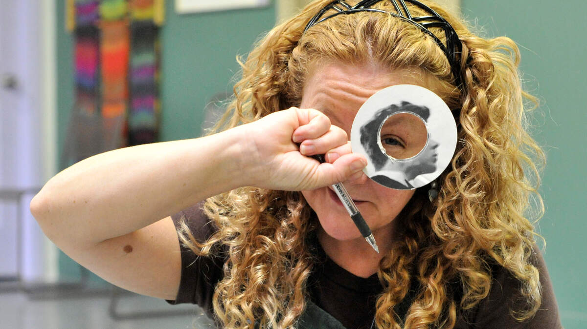 Christine Kuhn works on piece for "Records Reimagined," which will be a three dimesional work involving round slices of album covers at different levels on a spinning turntable. The piece she is holding up is a slice from an RCA album of Van Cliburn playing Tchaikovsky piano concertos, which Kuhn picked up at a Goodwill store. CD Central, 377 South Limestone in Lexington, Ky., presents "Records Reimagined," a show of album cover art by Central Kentucky artists, June 8 to July 8, 2012. Photo by Rich Copley | staff.