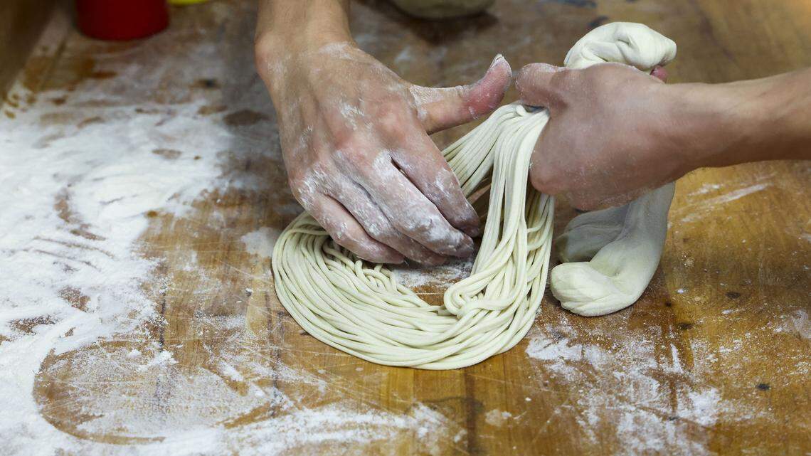 Jack Lin pulls and stretches dough for noodles at Kung Fu Noodle. Owner Dennis Zhang said noodles can be made into three shapes: round, flat and angular. The noodles are made to order and are chewy and fresh with the natural aroma of wheat.