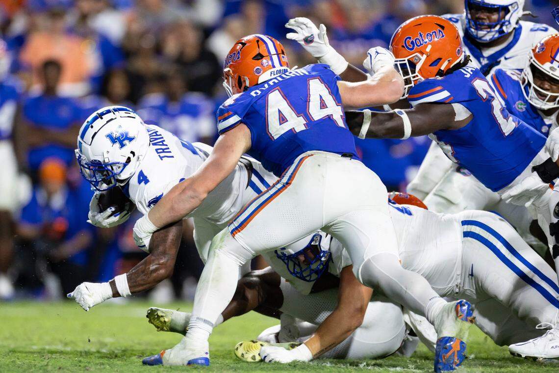 Oct 19, 2024; Gainesville, Florida, USA; Kentucky Wildcats running back Chip Trayanum (4) rushes with the ball while being tackled by Florida Gators defensive end Jack Pyburn (44) during the second half at Ben Hill Griffin Stadium. Mandatory Credit: Matt Pendleton-Imagn Images