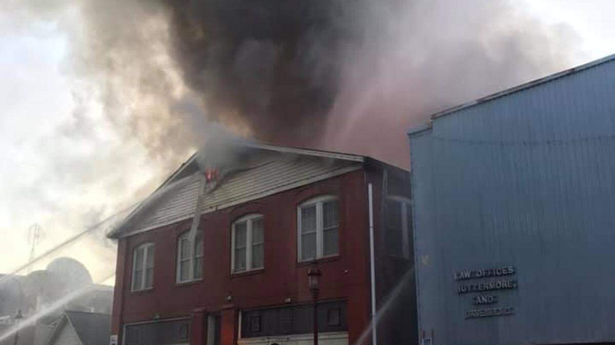 Police have charged a man with setting a fire that destroyed a building in downtown Harlan, Ky., on Nov. 28, 2020.