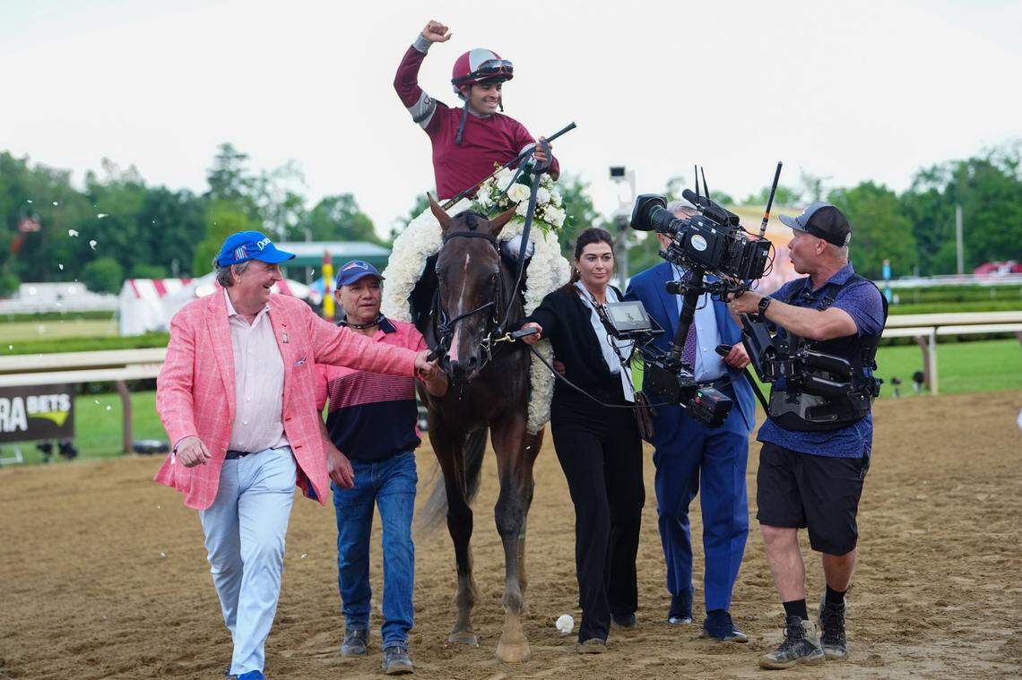 Jun 8, 2024; Saratoga Springs, NY, USA; Luis Saez raises his hand to celebrate winning the Belmont Stakes riding  Dornoch (6) at Saratoga Race Course. Mandatory Credit: Gregory Fisher-USA TODAY Sports