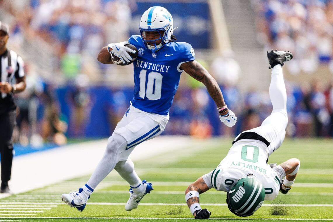 Sep 21, 2024; Lexington, Kentucky, USA; Kentucky Wildcats running back Jamarion Wilcox (10) runs by Ohio Bobcats safety Austin Brawley (0) during the first quarter at Kroger Field. Mandatory Credit: Jordan Prather-Imagn Images