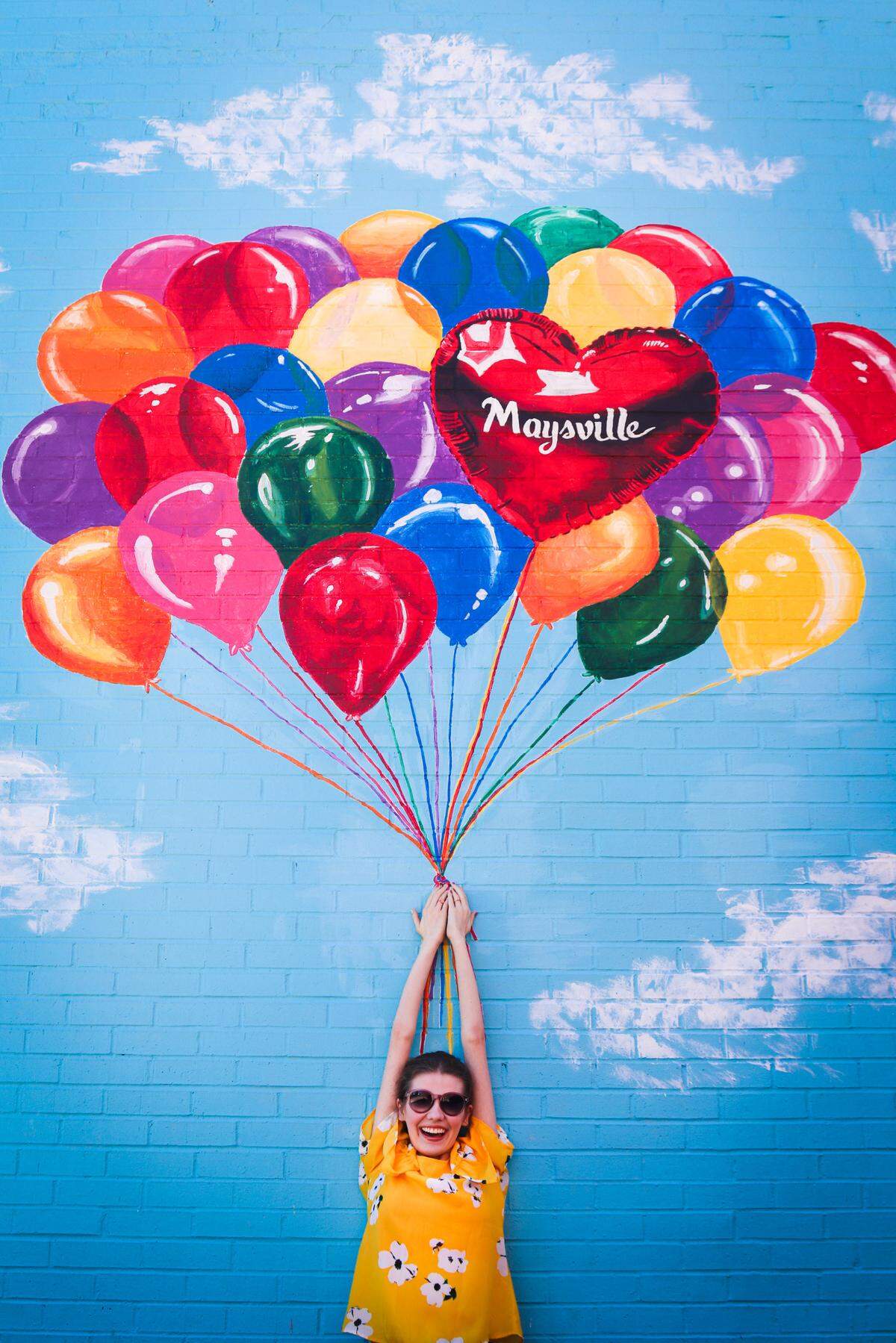 A mural of balloons on a building in downtown Maysville has become a popular spot for photos.