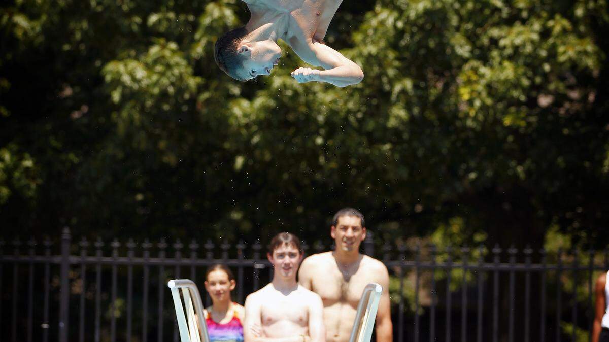 Andrew Smith, 17 got some air on the boards as kids flocked to Woodland Park swimming pool as temperatures hit 100+ degrees on Thursday June 28, 2012 in Lexington, Ky. Photo by Mark Cornelison | Staff