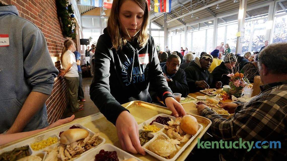 Ashton Lane served plates of turkey and fixings Saturday during the Lighthouse Ministries annual Thanksgiving dinner at Sayre School in Lexington.