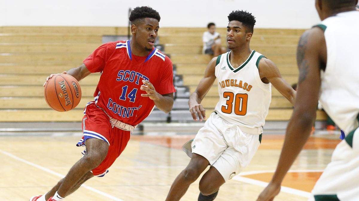 Glenn Covington, left, has committed to play football at Campbellsville University but Scott County Coach Billy Hicks has talked him up to Division I basketball coaches.