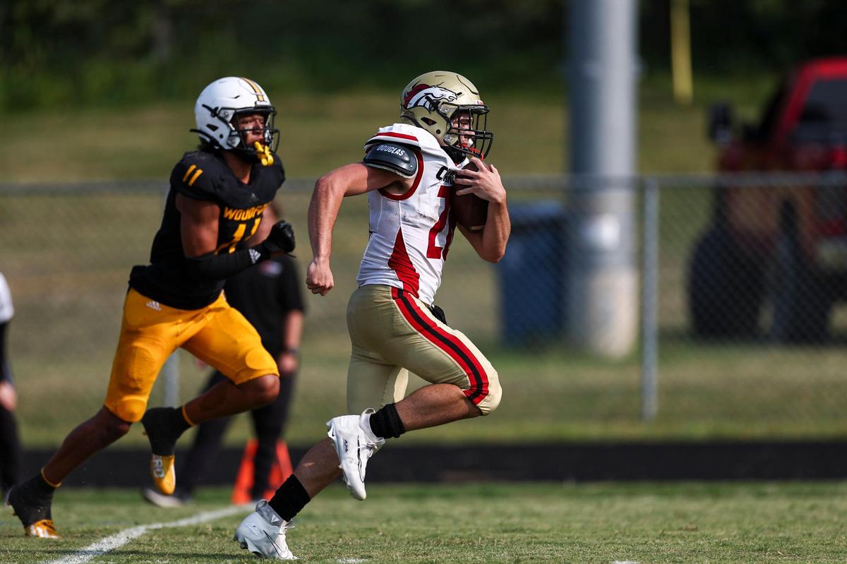 Bullitt East’s Mikey West (26) runs for a touchdown against Woodford County during the first game of the Fort Harrod Bowl at Alvis Johnson Field in Harrodsburg on Saturday.