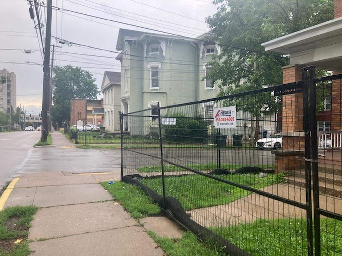 Buildings soon to be demolished are fenced in on East Maxwell near Lexington Avenue. Those buildings will be razed for a 6-story apartment complex. Lexington council recently approved a zone change for an 8-story building across from the 6-story apartments.