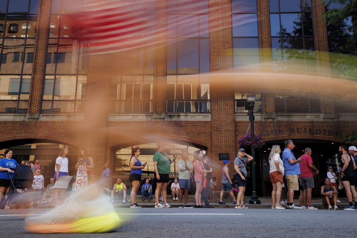 A runner, wearing American flag shorts, runs toward the finish line during the Bluegrass 10k race on Friday, July 4, 2025, at Main Street in Lexington, Ky.