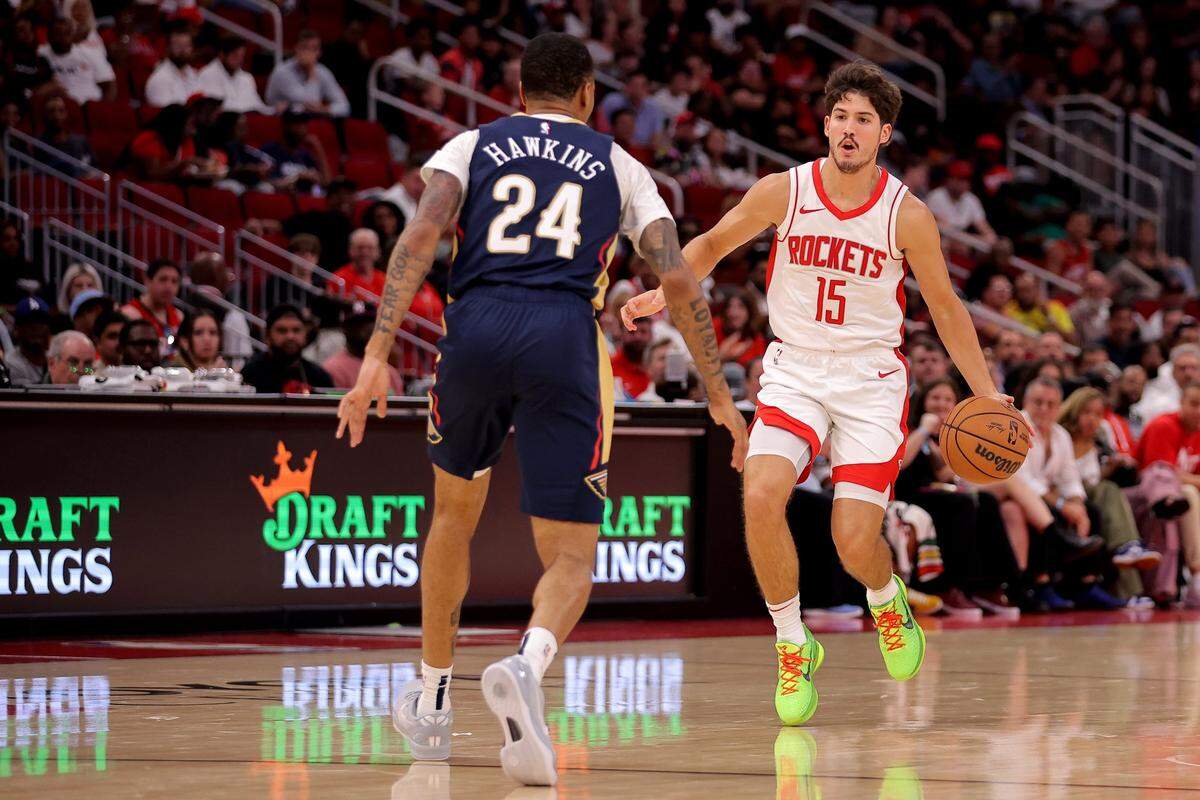 Oct 15, 2024; Houston, Texas, USA; Houston Rockets guard Reed Sheppard (15) handles the ball against New Orleans Pelicans guard Jordan Hawkins (24) during the third quarter at Toyota Center. Mandatory Credit: Erik Williams-Imagn Images