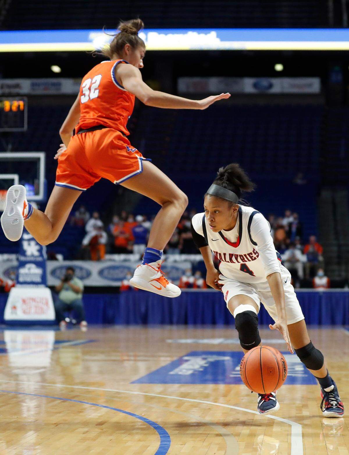 Sacred Heart’s Triniti Ralston (4) dribbled around Marshall County’s Sophie Galloway (32) during the Valkyries’ 49-47 win over the Marshals in the 2021 Kentucky Girls’ Sweet 16 championship game at Rupp Arena. “I will never, ever get over that,” said Galloway, now a Kentucky Wildcats triple jumper.