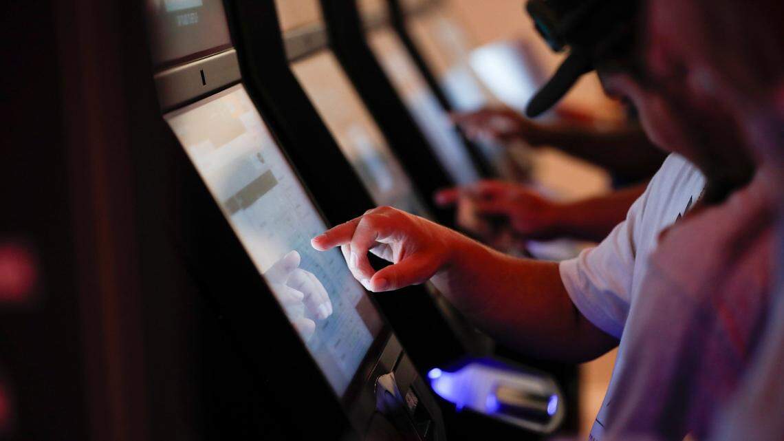 Patrons place bets after a press conference where Gov. Andy Beshear announces the opening of a Caesars Sportsbook and made comments on the first day of sports betting legalization in the Commonwealth at Red Mile in Lexington, Ky, Thursday, September 7, 2023.