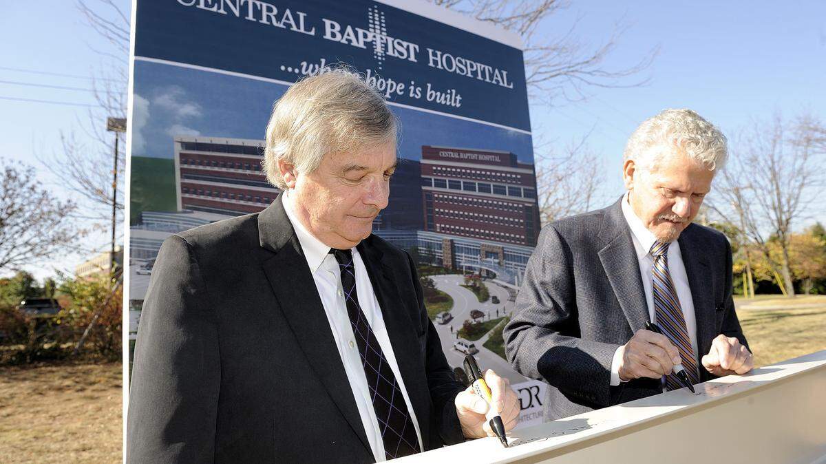 Bill Sisson, left, president of Central Baptist Hospital, and Tommy Smith, former president of Baptist Healthcare System, Inc., were the first of many to sign a steel beam that will be incorporated into the new hospital expansion in 2010. Smith died in 2018.