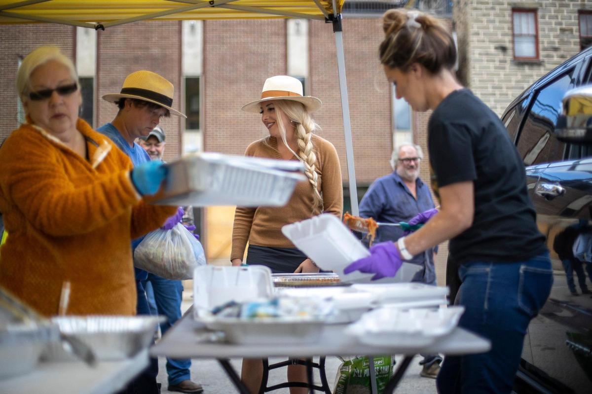 Kate Clemons, center, along with Sheila Seams, from left, Jennifer Eversole and Heather Hubbard, prepare lunch for people in Hindman, Ky., on Monday, Oct. 17, 2022.