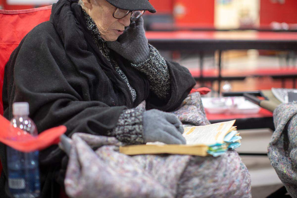 Wilma Sizemore, of Tyner, reads her bible to pass the time at a warming station set up at the Tyner Elementary school after she lost power at her home in Jackson County Jackson, Ky., Wednesday, February 17, 2020. Around 20 people stayed at the warming station until early Wednesday morning. Many people in the county have lost power and water at their homes after the winter storm passed through the area. The National Weather Service has forecasted another winter storm to drop snow Wednesday night and Thursday. “I think what is the worst for me is not being able to contact someone,” Sizemore said. She plans to stay at the warming station until she has power at her home again.