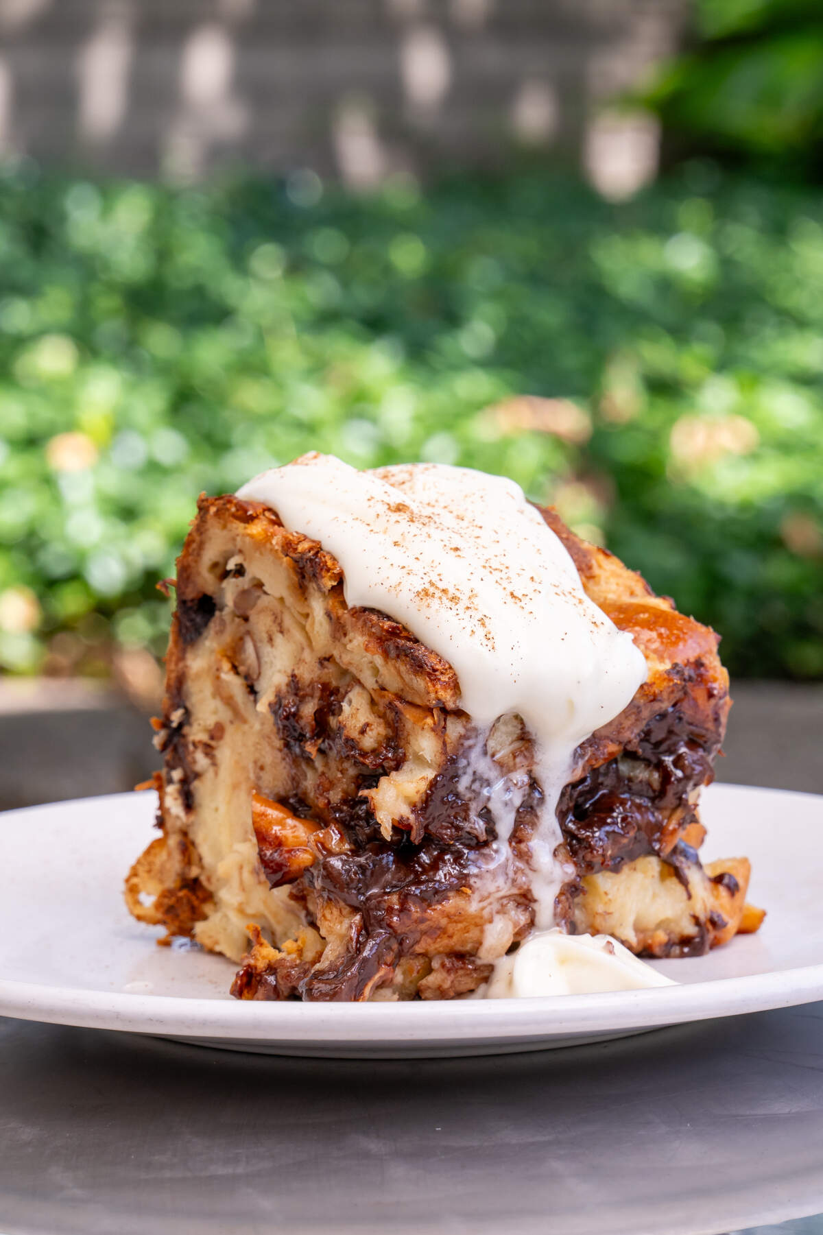 The new summer menu at Azur includes Chocolate Walnut Bread Pudding served warm with a sweet bourbon icing.