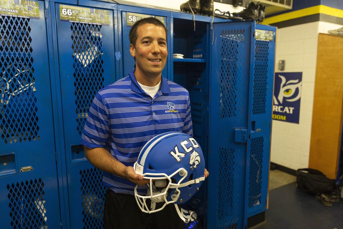 Kentucky Country Day School head football coach Matthew Jones holds new football helmets made by Vicis, a company out of Seattle, that claim to reduce impact forces in hopes of reducing head injuries in athletes.