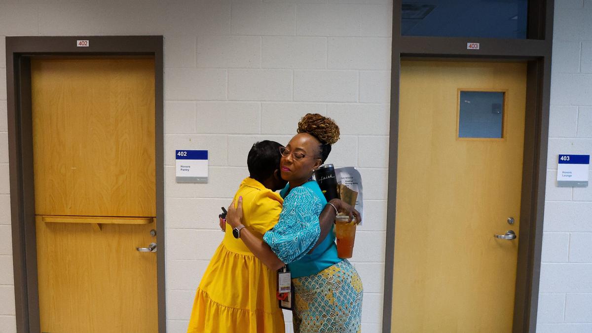 Program Director for the Audrey Grevious and Family Care Centers Felicia Lindsay, right, hugs teacher Monique Beckham on the first day of school for Fayette County Public Schools, Wednesday, Aug. 14, 2024, at the Audrey Grevious Center in Lexington, Ky.