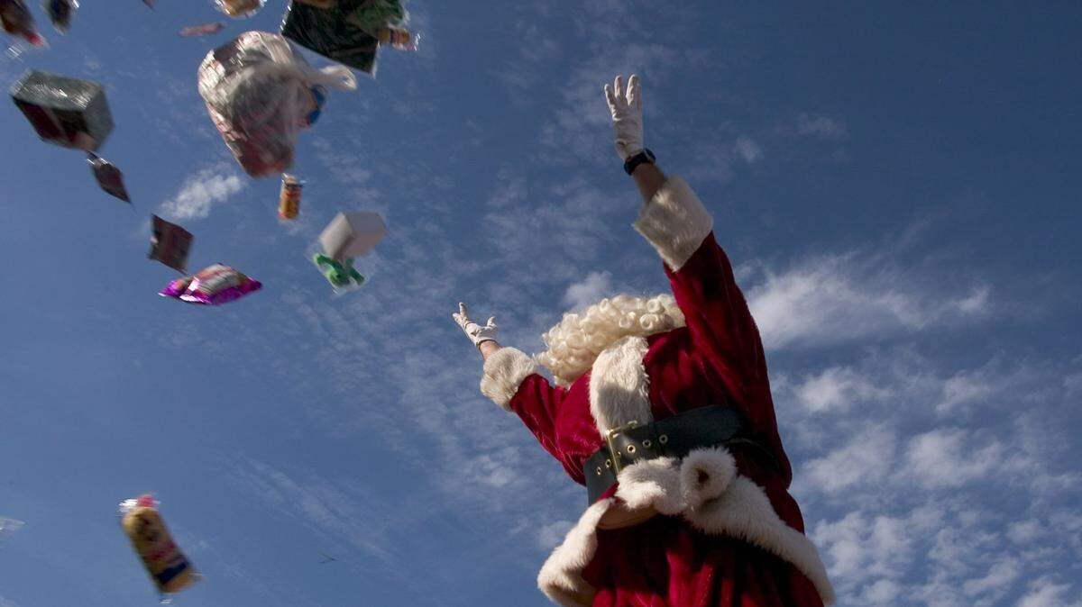 Don Royston disperses gifts and goodies to  children old and young on the Santa Train or Santa Special that wound through the mountains of Kentucky and Virginia bringing christmas joy  for people along the way.