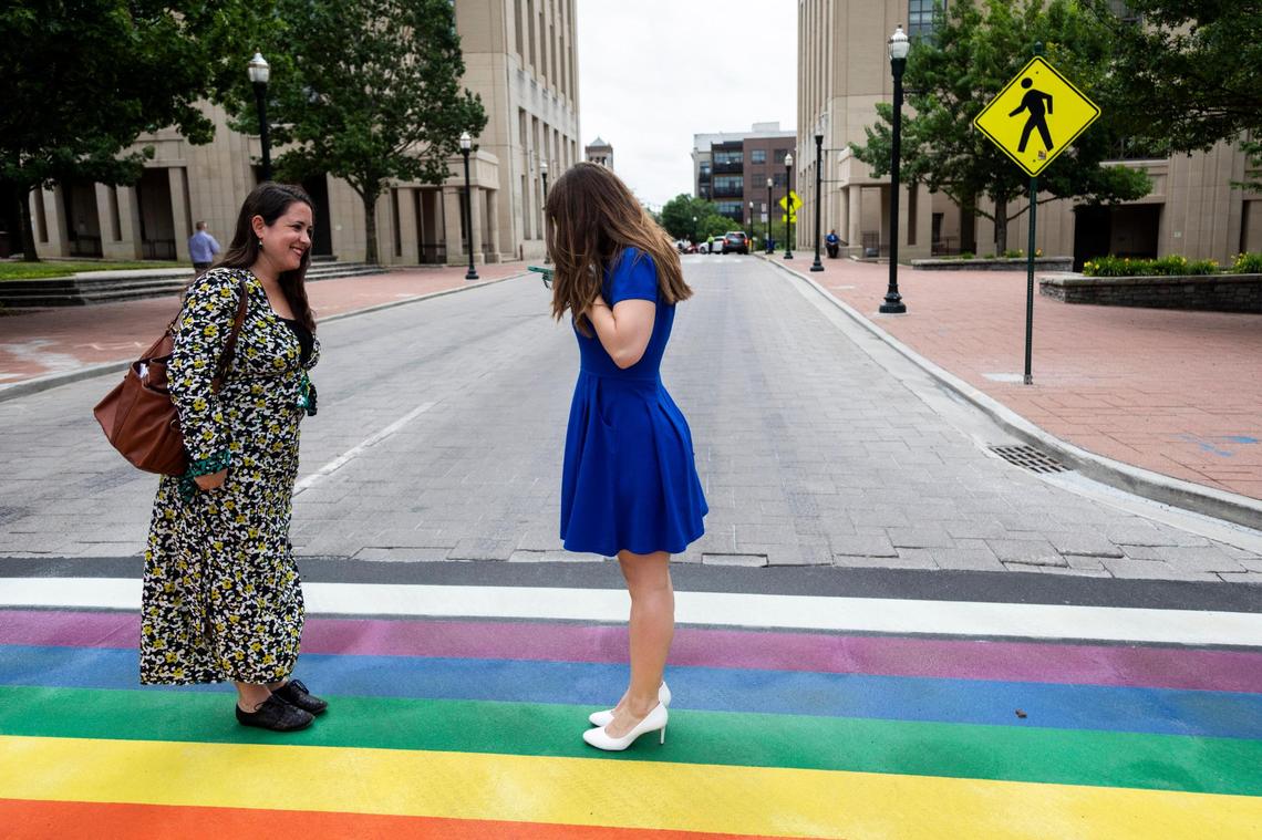 Lexington councilwomen Liz Sheehan and Jennifer Reynolds took photos on the freshly painted rainbow crosswalk after a press conference at the intersection of North Limestone and Short Street on Monday.