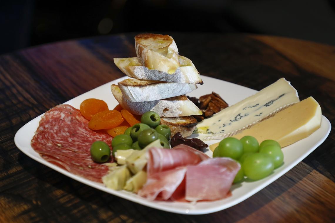 The antipasto plate made with grapes, cambozola and smoked gouda cheese, pecans, prosciutto, sopressata, artichokes, olives, dried apricots and fig jelly at the newly opened at Graze restaurant.