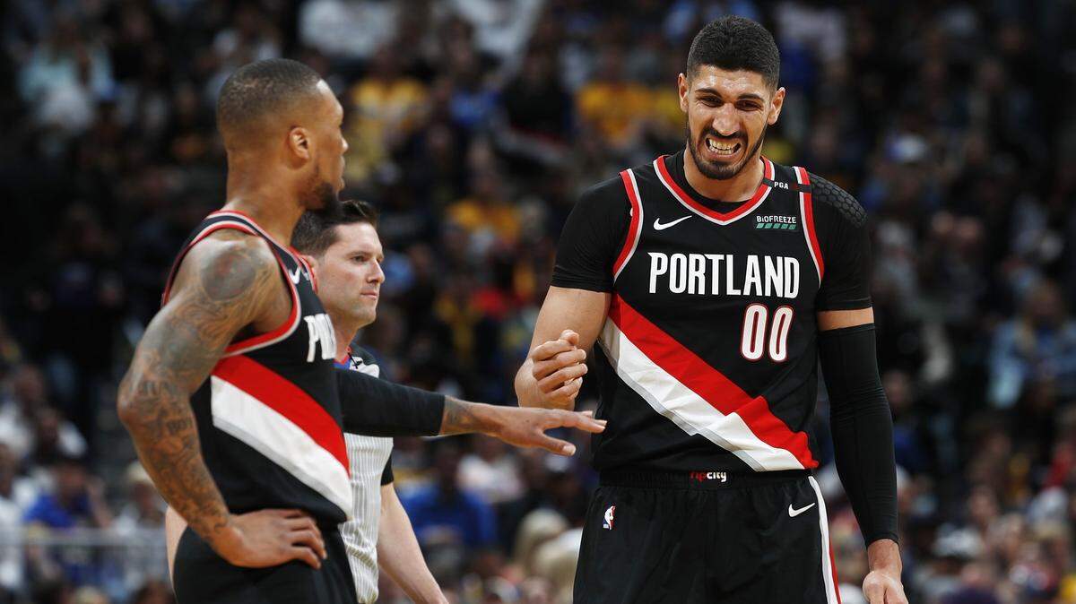 Portland Trail Blazers guard Damian Lillard, let, congratulates center Enes Kanter who reacts after hanging from the rim after putting the ball in for a basket against the Denver Nuggets in the first half of Game 1 of an NBA basketball second-round playoff series Monday, April 29, 2019, in Denver.