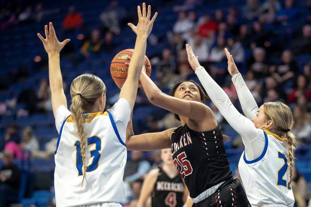 Destiny Thomas (25) looks to shoot the ball under duress from Bethlehem’s Carlie Thurmond (13) and Khloe Young (23) during McCracken County’s first-round victory Thursday.