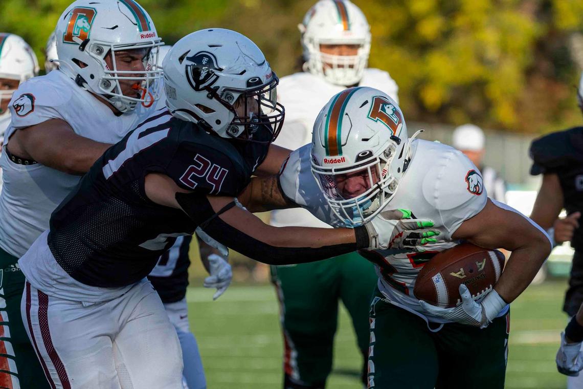 Frederick Douglass running back Peyton Smith (23) breaks the tackle of Tates Creek’s Maxwell Stump (24) on his way to a touchdown on his first touch as a Broncos player at Tates Creek High School on Friday.
