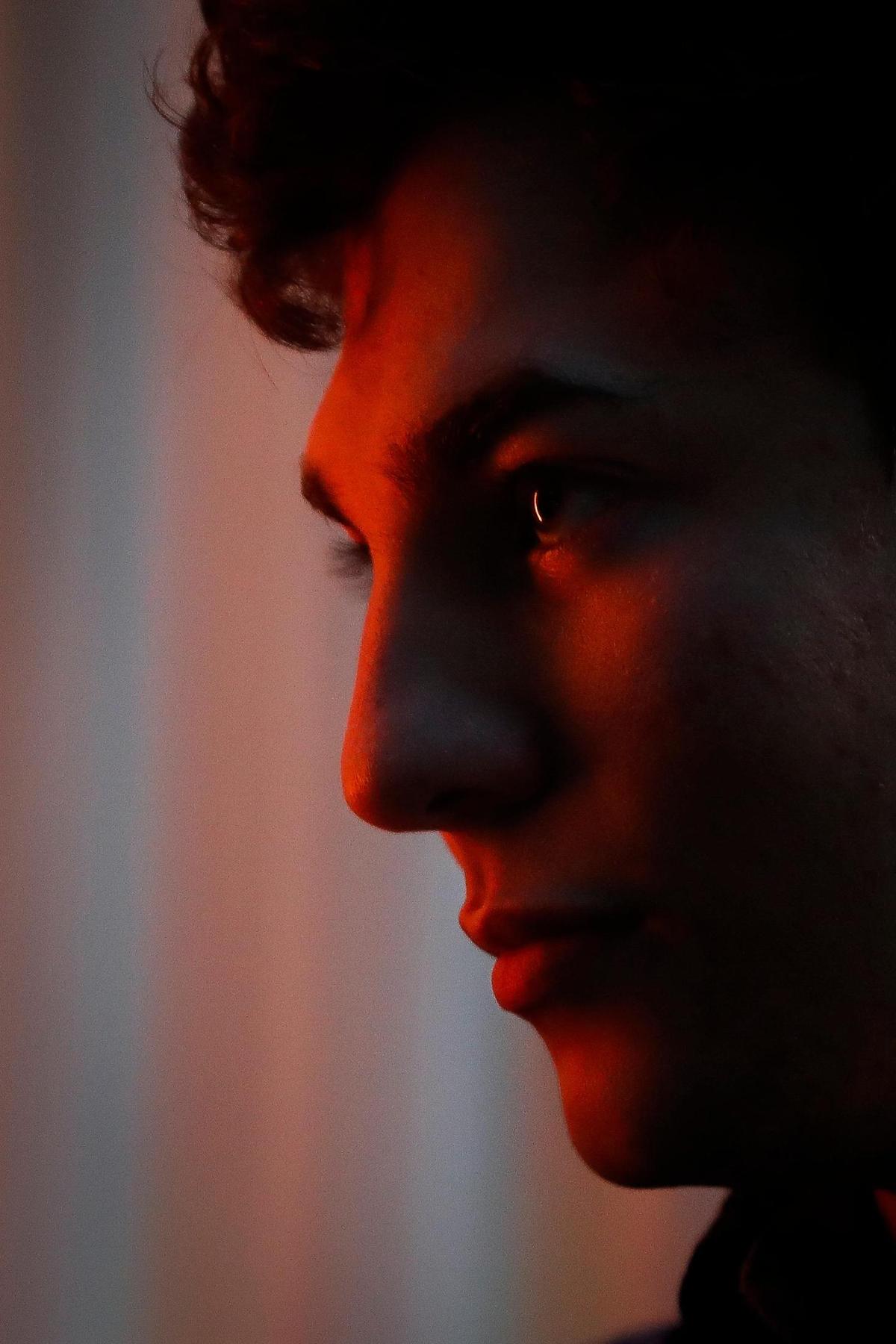 Joshua Scharfenberger is illuminated from the glow of a lightsaber during practice with the Lexington Lightsaber League. Scharfenberger recently joined the local club, which was established in 2019.