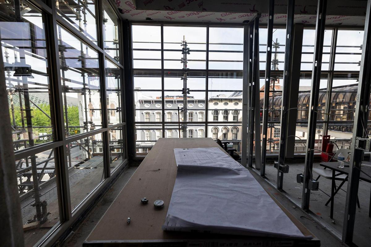 An unfinished office space overlooks North Broadway, as blueprints are spread across the table on Friday, June 20, 2025, at 325 Main Street in Lexington, Ky.