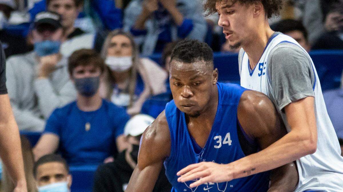 Oscar Tshiebwe (34) works in the post against Lance Ware (55) during Friday night’s Blue-White Game in Rupp Arena.