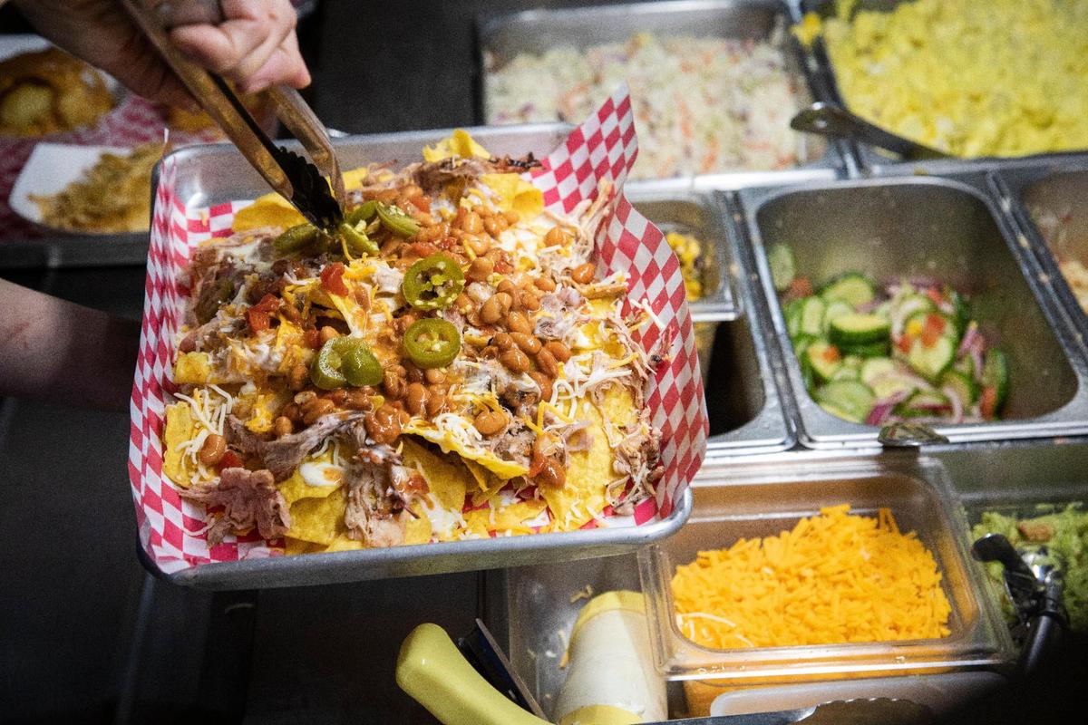 A plate of nachos are loaded with meat, beans and other toppings at Straight from Texas Bar-B-Que in Richmond, Ky., Thursday, May 6, 2021.
