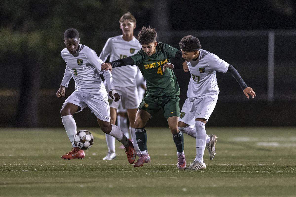 Bryan Station's Felicien Nzilamba (3), and St. Xavier's Graham Wheatley (4) battle for the ball during a game in Lexington, Ky., on Tuesday, Oct. 28, 2025.