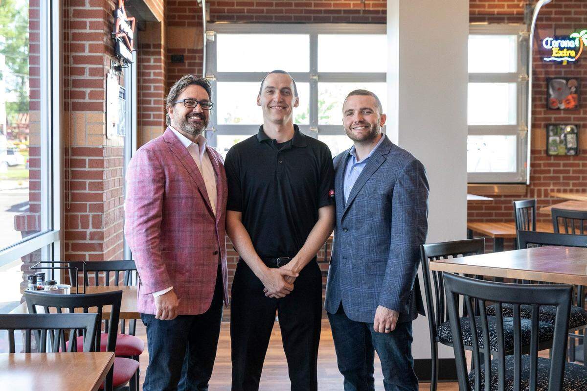 Gary Holland, from left, LaRosa’s co-owner, Tim Crofford chief operating officer, and Dillon Adams, co-owner, pose for a picture in the LaRosa’s on Richmond Road on Wednesday, May 8, 2019.