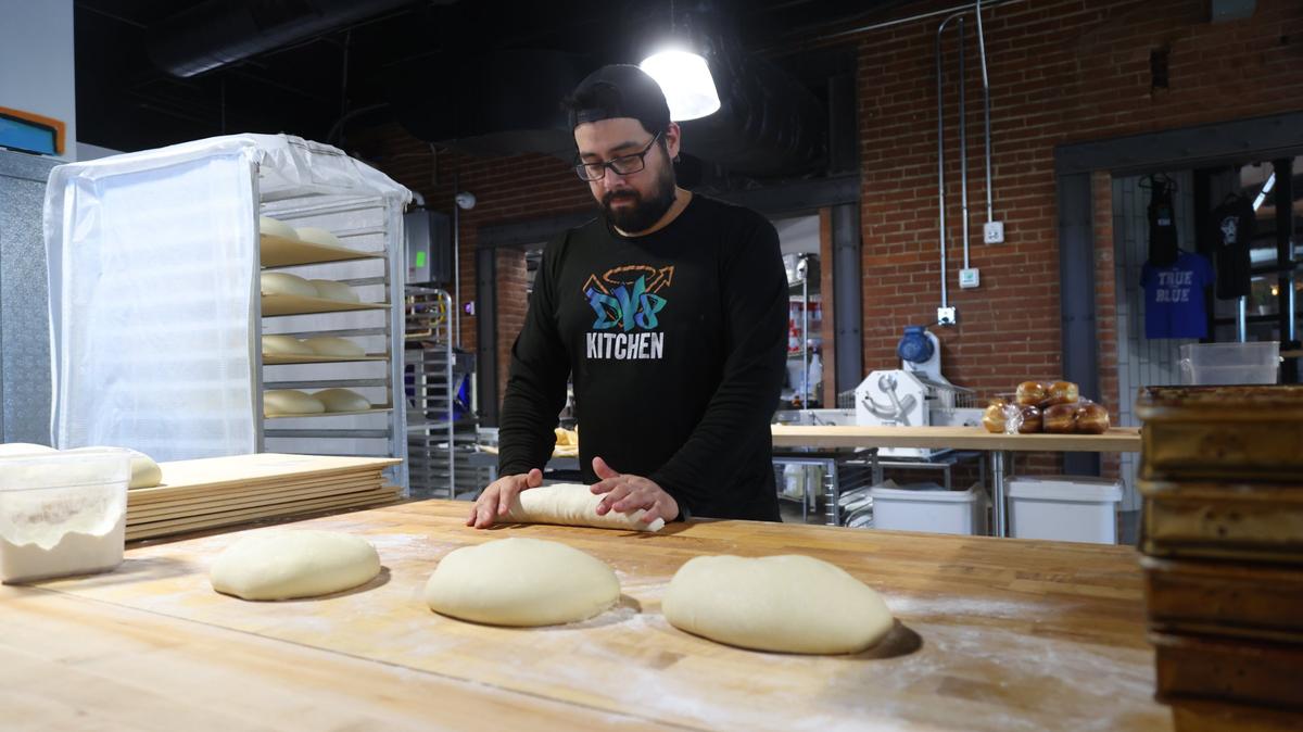 Pablo Villagaray, baker at DV8 Kitchen on the corner of East Third and Midland, kneads sourdough in the new 1,000-square-foot kitchen space.