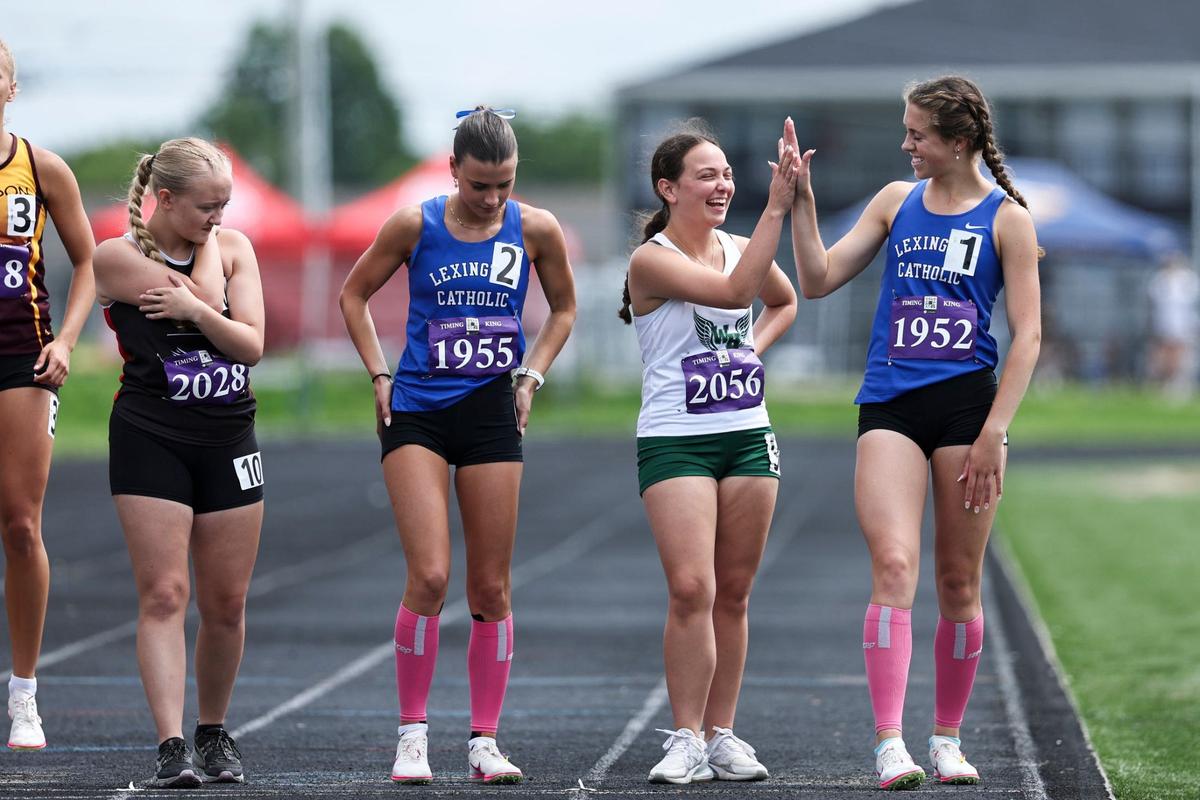 Lexington Catholic’s Caroline Beiting, right, competes during the 2A region track meet at Henry Clay High School on Saturday.