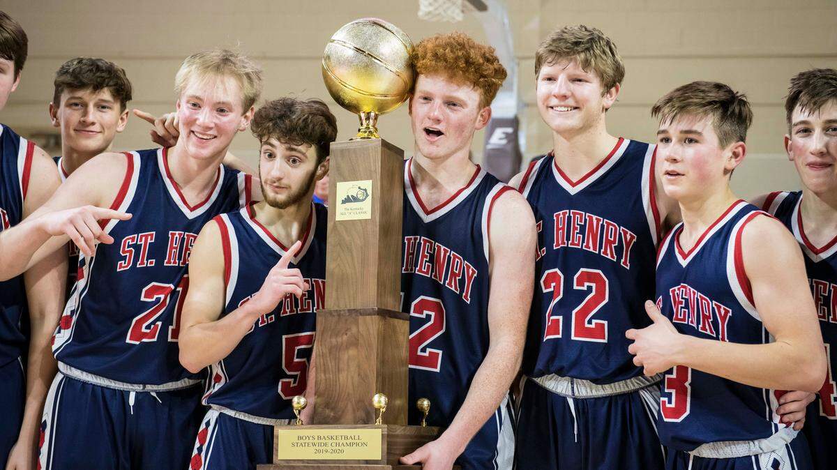 Left to right, St. Henry’s Luke Maher, Alex Daniel, Wyatt Vieth, Jude Bessler and Corey Shea, held the championship trophy after beating Frankfort, 77-70, during the finals of the All “A” Classic in Richmond last year. This year’s boys’ and girls’ small-school state championships have been rescheduled after an initial cancellation.