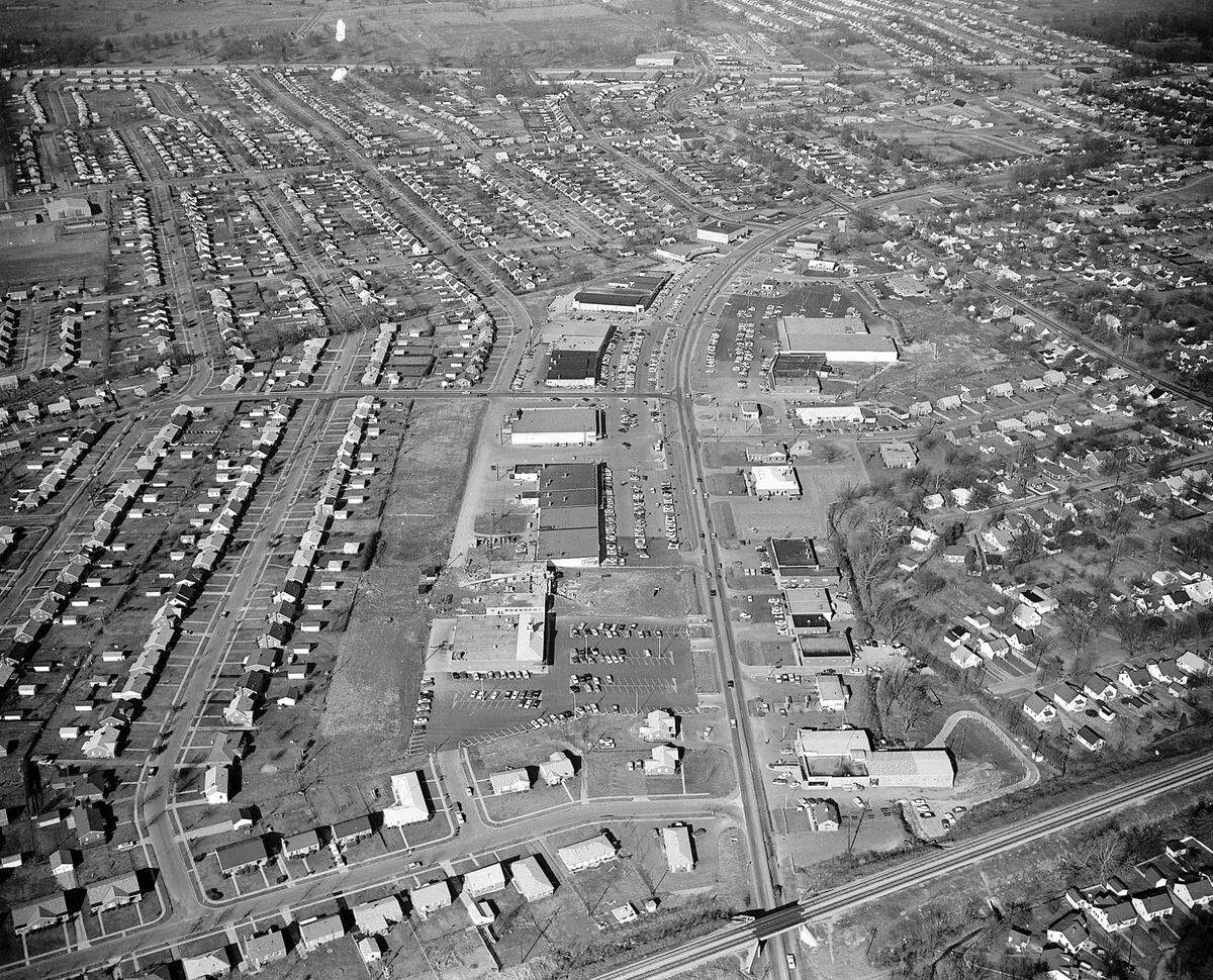 Aerial photo of Southland Shopping Center in Lexington, Jan. 1961. Running up the middle of the picture is Southland Drive and from left to right across the top is Harrordsburg Road. The farm land across the top would later be the site of Turfland Mall.