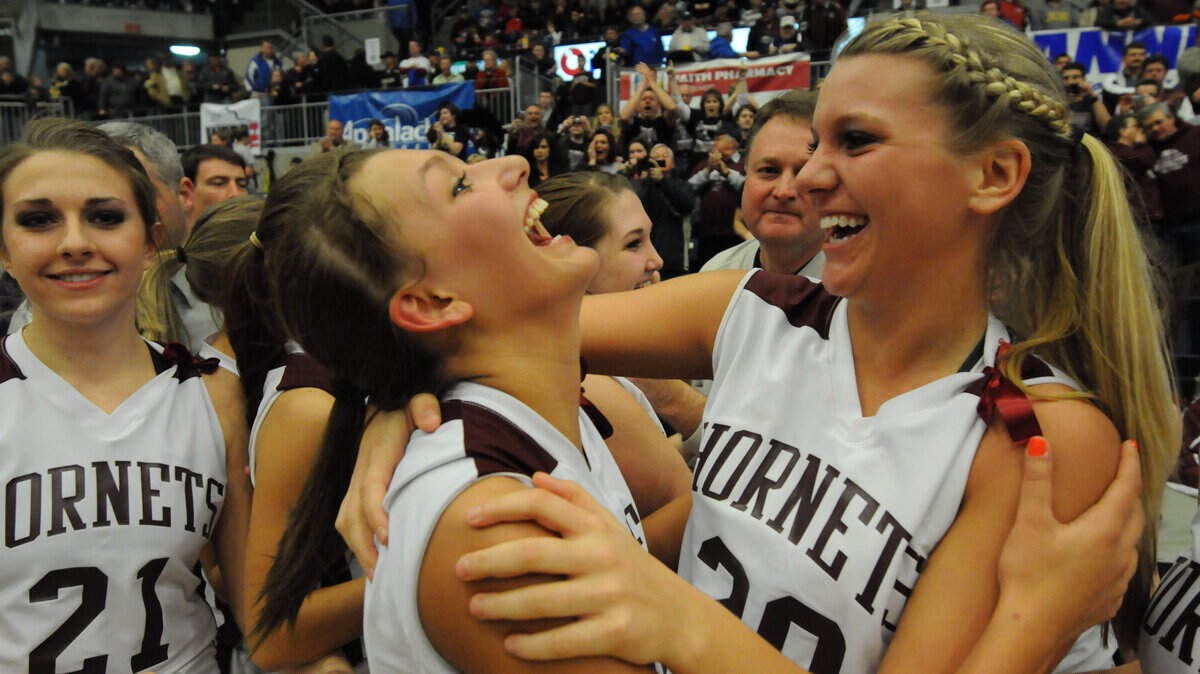 Magoffin County's Morgan Connelley, left, hugged teammate Nichole Fletcher following their win Monday in the 15th Region final at the Eastern Kentucky Exposition Center in Pikeville. "In a way, I almost feel guilty to be going to play basketball when so many people are hurting at home," Fletcher said later. "Part of me, I feel like I should be there to help. Yet, we're so excited to be going to state."            
