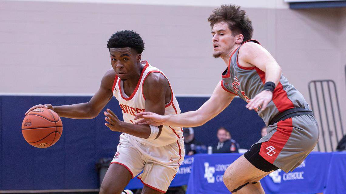 Daviess County's Jonathan Moss (11) dribbles past Boyd County's Gunnar Woods (3), moving the ball down court during the White, Greer & Maggard Holiday Classic championship game on Dec. 30, 2025, in Lexington, Ky.