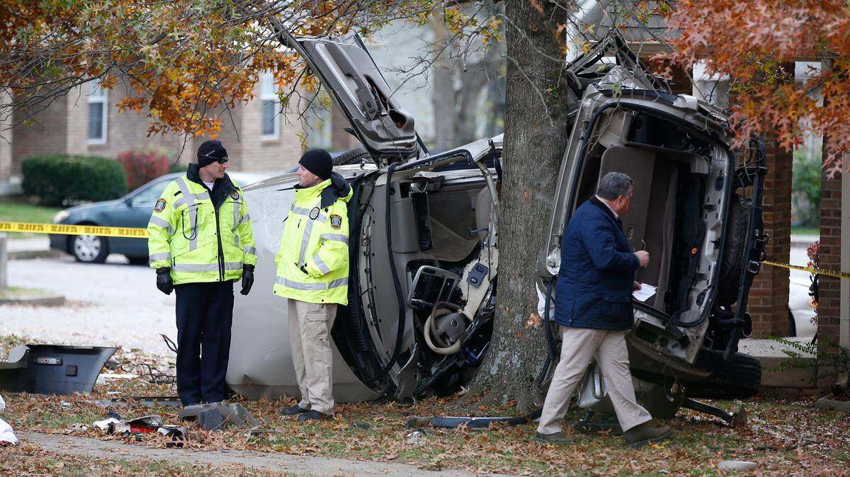 Coroner Gary Ginn, right, worked at the scene of a fatal crash on Camelot Drive in Lexington in November 2018. New traffic data for the year showed the number of fatal wrecks — 31 — in 2018 was down 8.8 percent from 2017, but the number of fatalities was still larger than any year from 2012 to 2015.