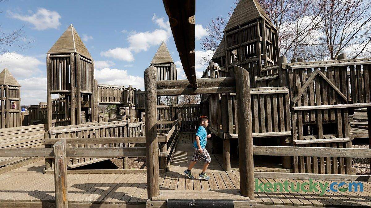 Christian Bautista, age eight, chased playmates around the creative playground at Jacobson Park in  Lexington, Ky., on March 25, 2015. The city is looking for design proposals to build a new playground at Jacobson Park to replace a wooden, creative playground that was built in the early 1990s by volunteers. Photo by Pablo Alcala | Staff