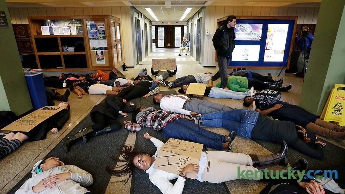 About 40 protesters including Kelly Moore, front, center, held a silent "die-in" demonstration Tuesday at the University of Kentucky's Patterson Office Tower to protest police killings of black men. Students and faculty had to walk around the protesters. Moore was a co-organizer of the protest, which lasted about 30 minutes.
