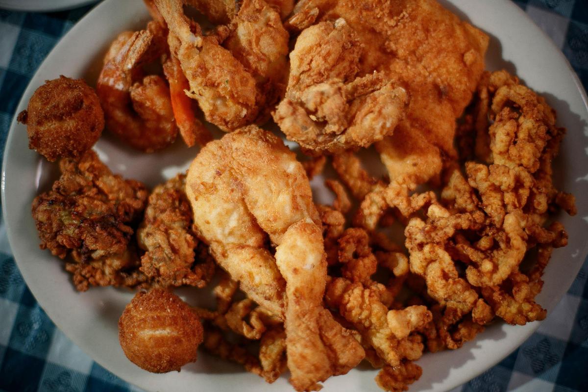The Mix and Match dinner platter with whitefish, gulf shrimp. frog legs, fried oysters, clam strips and hush puppies, served with a baked potato and cole slaw at Jim’s Seafood.