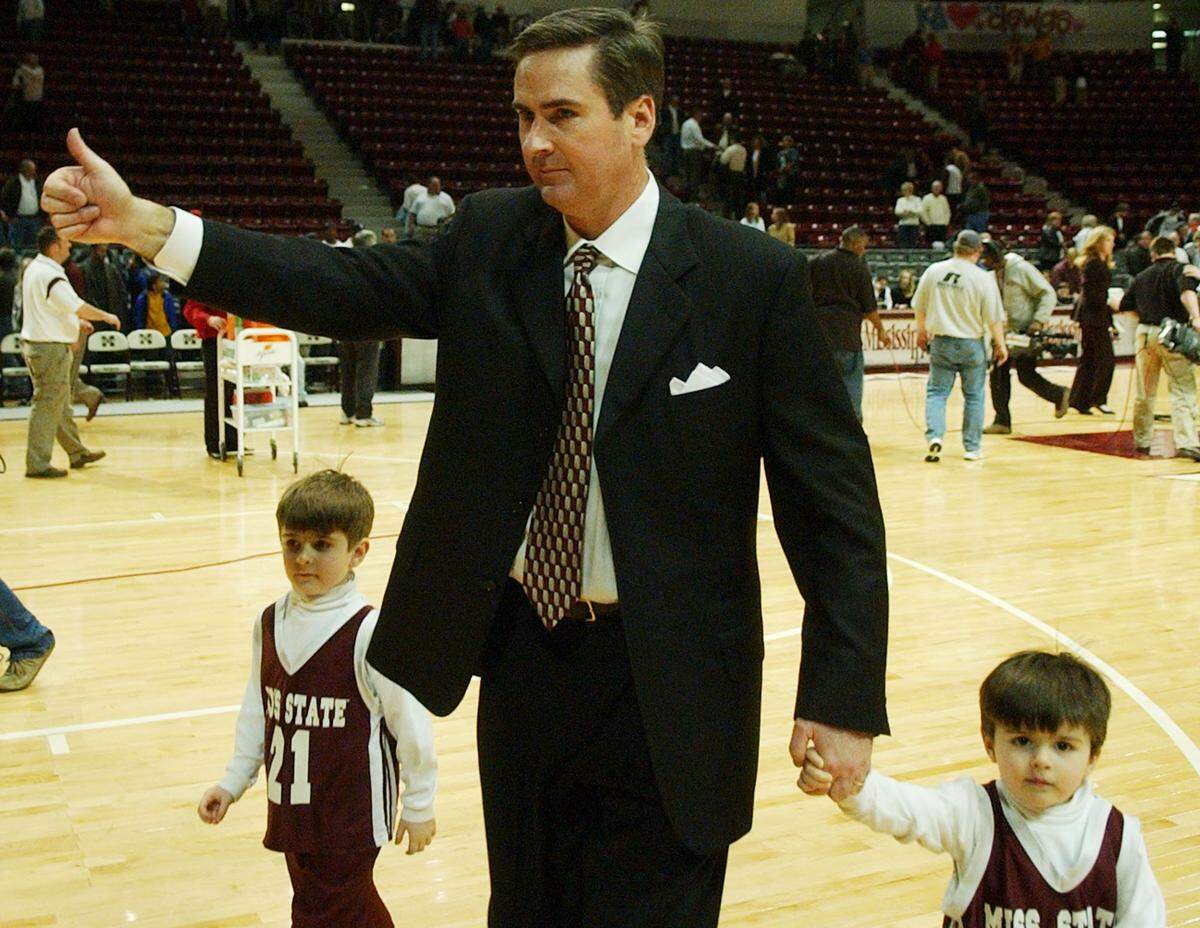 Rick Stansbury, then the coach at Mississippi State, gives the student body in Humphrey Coliseum a “thumbs up” as he is escorted from the floor by two of his sons, Isaac, 5, left, and Noah, 2, in Starkville, Miss., on Feb. 1, 2005, following a victory over Florida. Rick and Noah are now at Western Kentucky as coach and player, respectively.