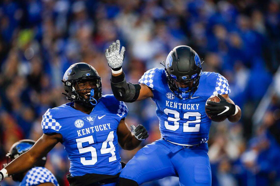 Kentucky Wildcats linebacker Trevin Wallace (32) celebrates an interception against the Louisville Cardinals in the second half of the Governor’s Cup at Kroger Field in Lexington, Ky., Saturday, November 26, 2022.