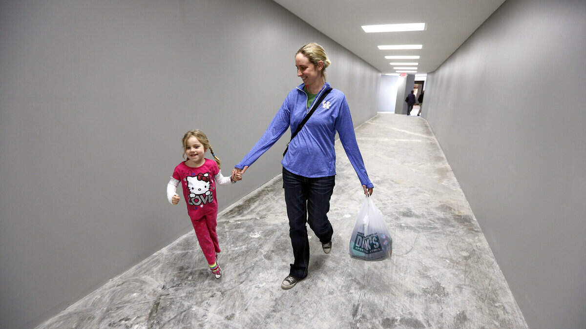 Four-year-old Lydia Neltner skipped with her mom, Janna Neltner, as they headed through the new walkway from the south wing of Fayette Mall to the north wing as work continued on the demolition and conversion of the former Sears store.