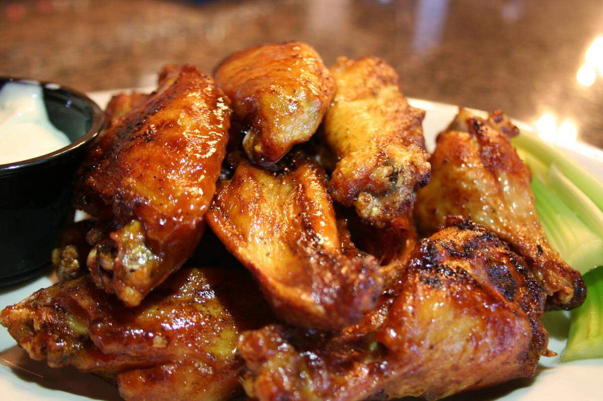 J. Render’s smokes its wings and you can get them “naked” or in a variety of barbecue sauces. Place big orders early to make sure you get them.