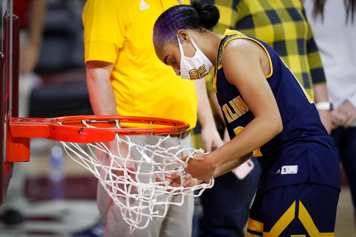 Franklin County’s Brooklynn Miles cut a piece of the net after her team’s 53-38 victory over Lafayette in the girls’ 11th Region Tournament championship game at McBrayer Arena in Richmond on Saturday.